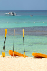 Wall Mural -  Orange boats with oars on the sandy shore. Beautiful seascape on the Caribbean Sea in the Dominican Republic