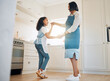 © Kay A/peopleimages.com - I think my mom is amazing. Shot of a little girl and her mother dancing in the kitchen at home.