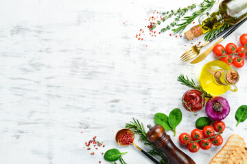 Wall Mural - White wooden background of cooking. Spices and vegetables. Top view. Free space for your text.