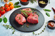 Raw veal medallions. Veal tenderloin is ready for cooking. Meat. On a stone background.