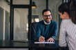 © bnenin - Smiling male with glasses, talking with a woman about employment
