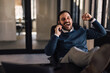 © bnenin - Businessman laughing while talking to someone, over the phone.