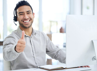 Aufkleber - Customer satisfaction comes first. Shot of a young businessman using a headset and showing thumbs up in a modern office.