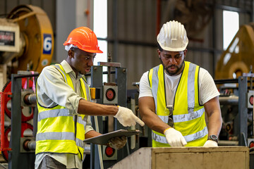 team of african american industrial worker is checking the setup value of metal sheet roll forming m