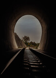 Fototapeta  - Inside the railroad tunnel and railways with natural light at the end. Light at the end of the tunnel, Lights and shadows, Concept of achieving your goals, Copy space, No focus, specifically.
