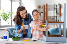 Family, Diy And Home Improvement Concept - Happy Smiling Mother And Daughter With Ruler Measuring Old Wooden Table For Renovation At Home