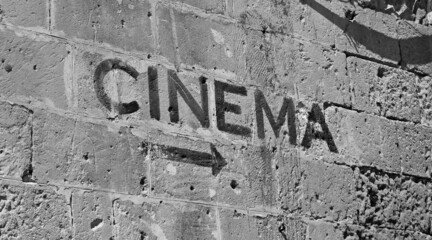 Italy: Direction for cinema written on the wall.