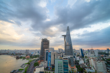 Aerial view of Bitexco Tower, buildings, roads, Thu Thiem 2 bridge and Saigon river in Ho Chi Minh city - Far away is Landmark 81 skyscrapper. This city is a popular tourist destination of Vietnam