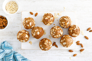 Canvas Print - Muffins with flaked almond nuts. Cupcakes with nut chips. Top view