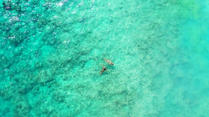 Poster - Top view of Caucasian and East Asian girls swimming in the Bali sea, Gili Meno, Lombok, Indonesia