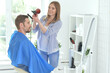 © aletia2011 - Man having a haircut from female hairdresser at salon