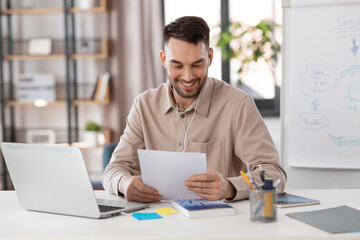 Poster - distant education, school and remote job concept - happy smiling male teacher with laptop computer and wireless earphones working at home office