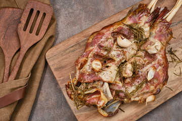 Wall Mural - Two roasted lamb shoulder with garlic, rosemary. Lamb meat, shoulder of mutton with spices. Lamb leg fillet ready to eat. Selective focus.