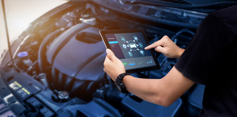 Smart Car Service  Diagnostics Software concept.Mechanic using digital tablet Inspecting the Vehicle