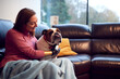 © Monkey Business - Woman With Prosthetic Arm And Hand At Home With Pet Dog