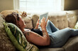 © Chanelle M/peopleimages.com - With wifi comes a lot of relaxation. Shot of a young woman using a digital tablet on the sofa at home.