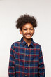 © Anatoliy Karlyuk - Human emotions and feelings. Studio shot of funny-looking dark-skinned male kid in stylish shirt and afro haircut, looking at camera with cute toothy smile, feeling happy and joyful