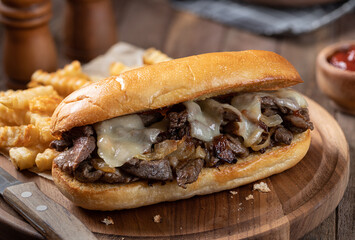 Wall Mural - Philly cheesesteak sandwich and french fries