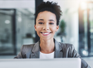 Wall Mural - always happy to be productive. cropped shot of an attractive young businesswoman in her office.