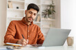 © Prostock-studio - Portrait of focused Arab man using pc and writing
