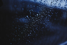 Drops Of Water On The Glass. Rain Outside The Window. Blue Texture Background. Cloudy Rainy Day