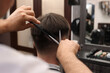 © New Africa - Professional hairdresser cutting man's hair in barbershop