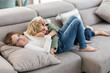 © ADDICTIVE STOCK - Cheerful siblings playing on sofa