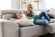 © ADDICTIVE STOCK - Cheerful siblings playing on sofa