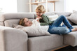 © ADDICTIVE STOCK - Cheerful siblings playing on sofa