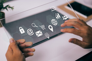 Aufkleber - In a modern workplace with virtual icons interface, a businessman works with a digital tablet, a book, and a document.