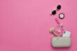 © Natalie Portman/Wirestock Creators - Content of a female purse on a pink background