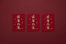 Flat Lay Of Chinese Red Envelopes For Money Isolated On A Dark Red Background