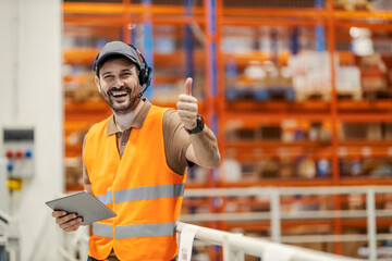 Wall Mural - A delivery center manager showing thumbs up and smiling at the camera.