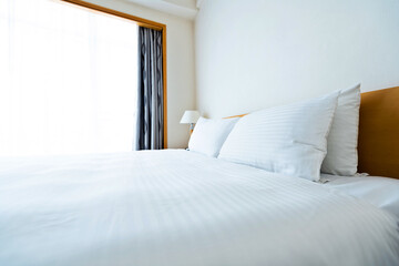 Wall Mural - White bed sheet and pillows in hotel room