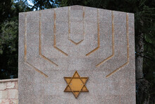 A Menorah Or Jewish Candelabra And Jewish Star Of David Adorn A Memorial Stone In The Mt. Herzl Military Cemetery In Jerusalem.