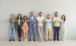 © Studio Romantic - Business team doing thumbs up together. Studio group portrait of happy successful young and senior people standing in row, giving thumbs up and smiling, sharing positive review or supporting best idea