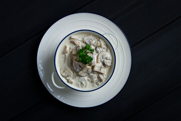 Wall Mural - Cream sauce with mushrooms, top view, on a dark gray wooden table, horizontal , no people,