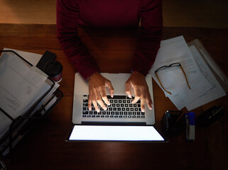 Aufkleber - Working hard to meet the project deadline. High angle shot of an unrecognizable man working late in the office.