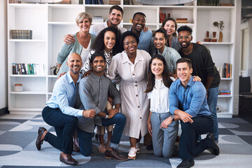 Poster - Coming together to give our best so we can achieve success. Portrait of a diverse group of businesspeople standing together in an office.