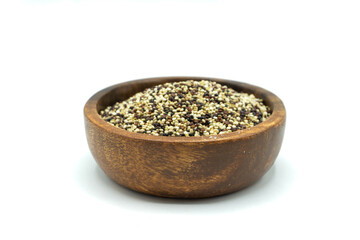 Red white quinoa grains  in wooden bowl isolated on white background