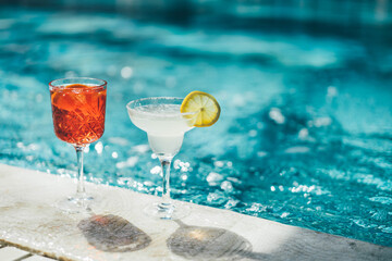 Refreshing cocktail near swimming pool, close up