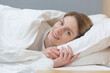 © Liubomir - Close-up photo of portrait of woman sleeping in bed smiling and looking at camera in the morning