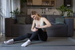© Liubomir - A woman injured her leg and knee at home during morning exercises, massages, and is in severe pain