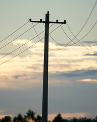 Wall Mural - Selective focus shot of an electricity tower during the sunset