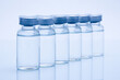 Closeup of medicine or injection vials in a row isolated on a white background