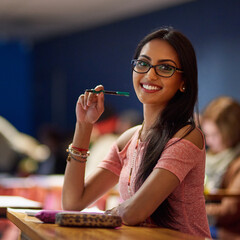 Wall Mural - Im going to ace my exams. Portrait of a beautiful university student making notes while sitting in a lecture hall.