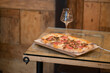 pinsa romana on wood table pizza with glass