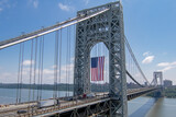 Bright morning at the George Washington Bridge in Fort, USA with the US flag hanging from it