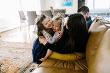 Family Of Five Playing And Spending Time Together On Couch