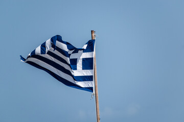 View of the Greek flag isolated in a clear blue sky